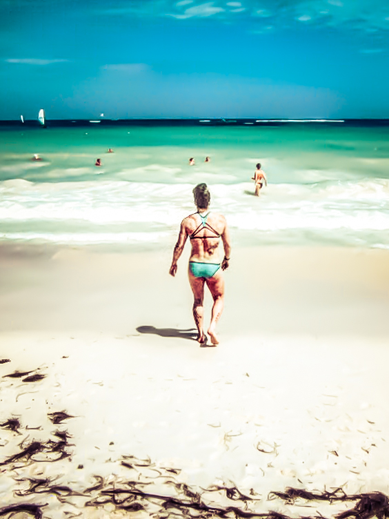 Picture of a woman on the beach walking towards the ocean in Punta Cana