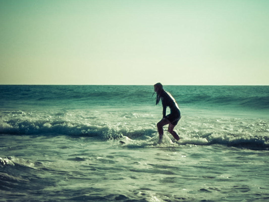 Picture of a woman surfing in the sea of France