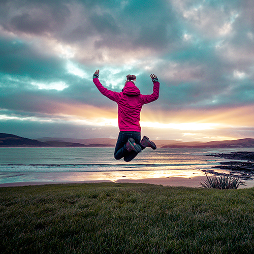 Travelher Woman jumping in NZ