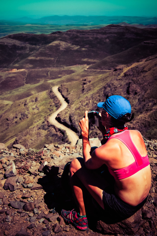A woman overlooks the steep trail she just ran in Africa