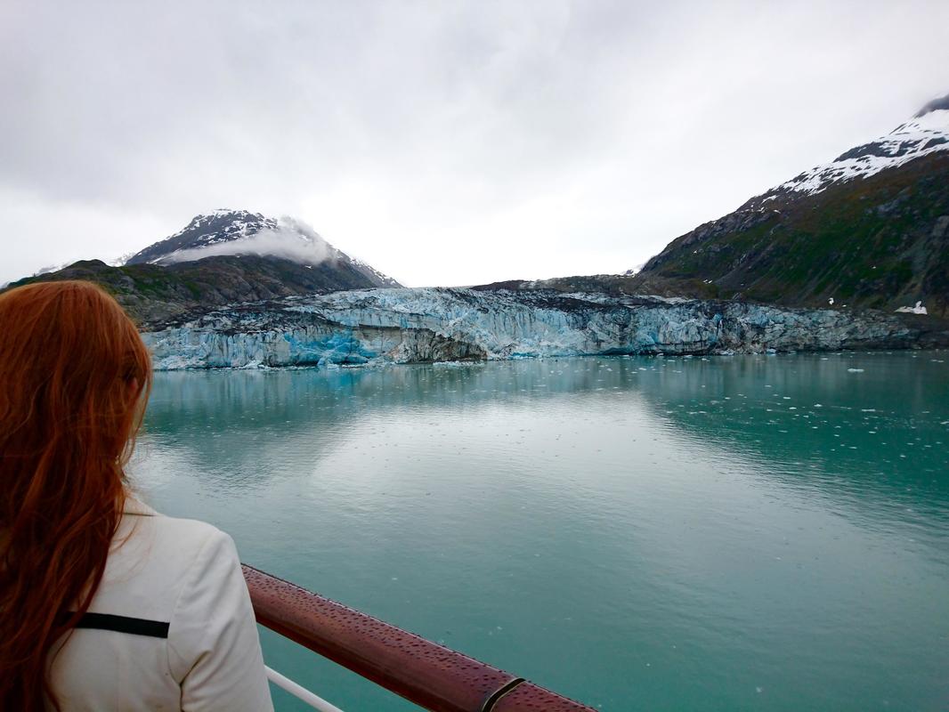 Woman overlooks Alaskan glacier from a cruise ship