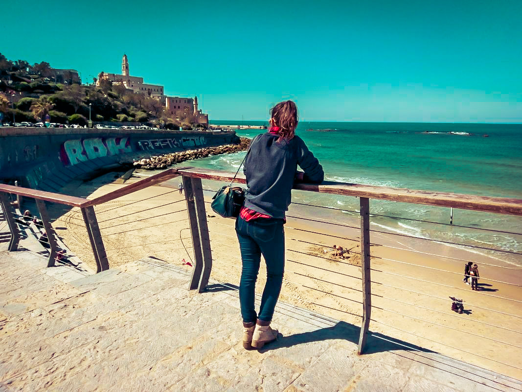 Woman overlooking the beach and sea in Jordan