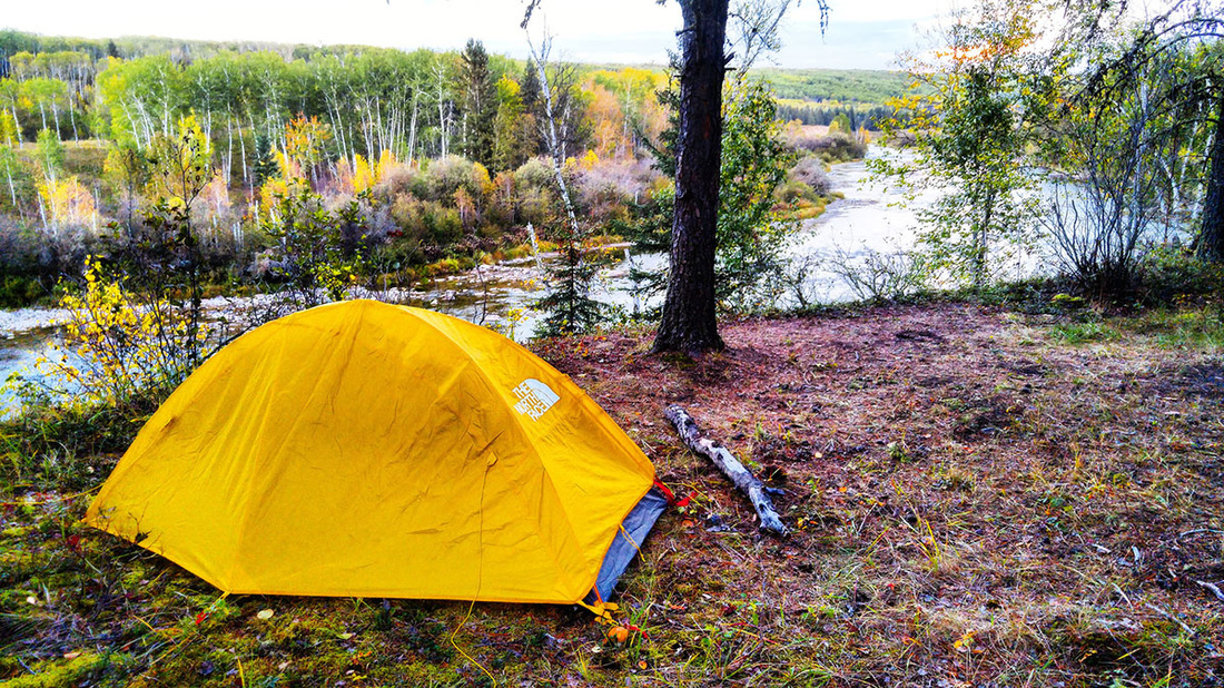 Yellow tent set up along Saskatchewan hiking trail