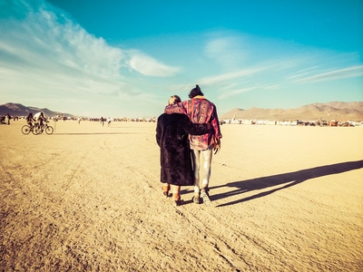 Woman and man walking together at Burning Man
