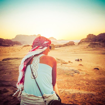 Woman overlooks landscape wearing headdress in Turkey