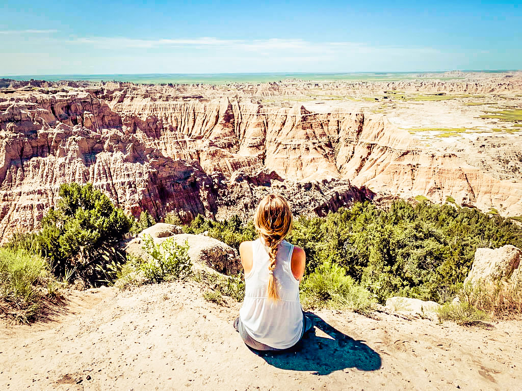 Girl overlooks canyons in the Badlands of South Dakota