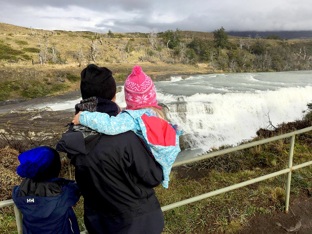 Picture of a woman with two kids overlooking a waterfall - Torres del Paine, Patagonia