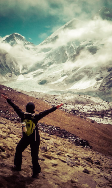 Woman triumphantly posing in Himalayan mountains