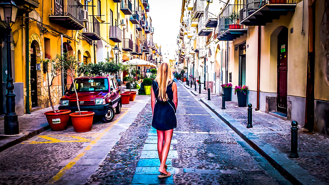 Picture of a woman standing in an alley way in Sicily, Italy