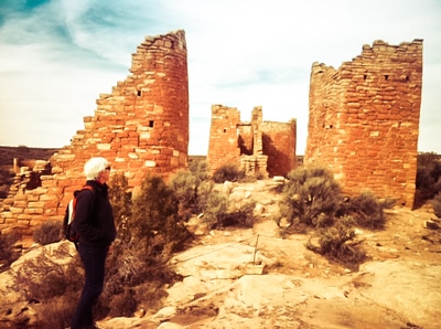 Woman exploring brick structures in the desert