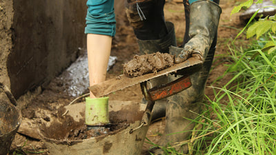 Woman preparing mud for building