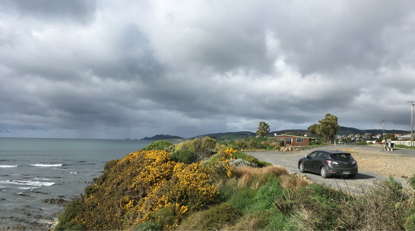 Car parked at a seaside cliff in the South Island of New Zealand