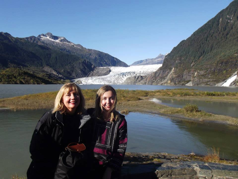 Mother and daughter pose in front of Alaskan glacier